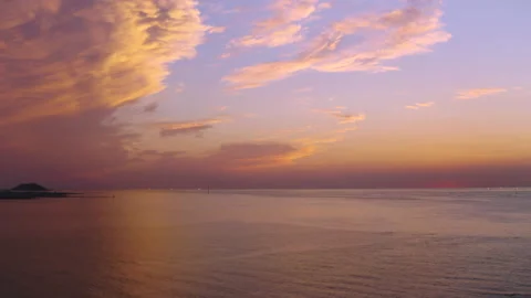 The romantic scene of the sun setting on the horizon of the vast ocean. Drone sh Stock Footage 139699854