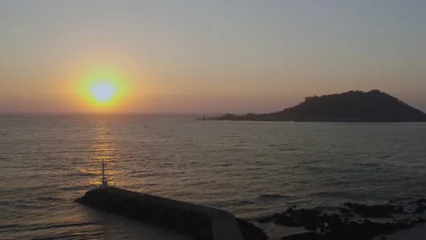 A romantic scenery where the setting sun illuminates the lighthouse and island. Stock Footage 138691607