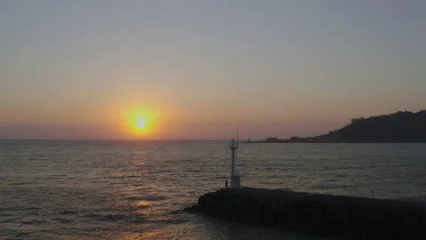 A romantic scenery where the setting sun illuminates the lighthouse and island. Stock Footage 138691788