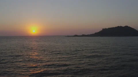 A romantic scenery where the setting sun illuminates the lighthouse and island. Stock Footage 138692007