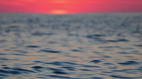 Romantic seascape at sunset with vibrant sky and gentle waves, relaxing 4K slow Stock Footage 334128884