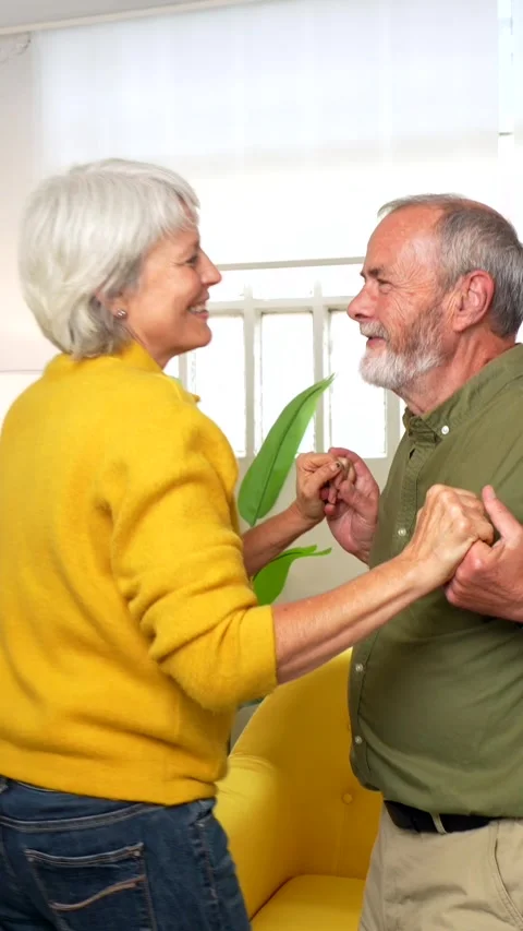Romantic senior couple dancing together in the living room Stock Footage 291436124