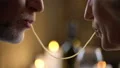Romantic senior couple eating spaghetti and kissing, man and woman date dinner 4k or 4k+ Resolution