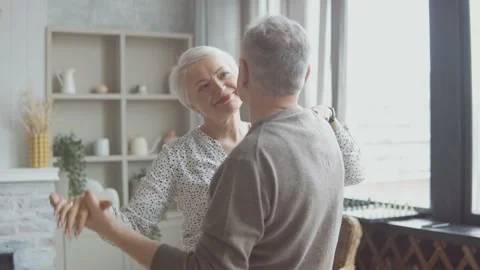 Romantic senior couple having fun while dancing at home Stock Footage 172192248