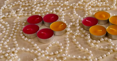 Romantic setting lit candles and pearl beads Stock Footage 142543683