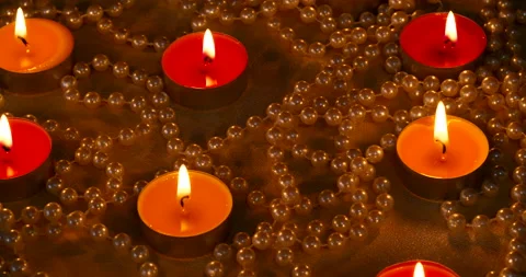 Romantic setting lit candles and pearl beads Stock Footage 142556451
