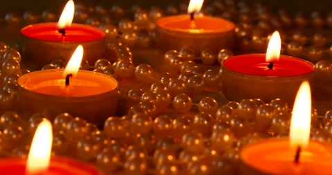 Romantic setting lit candles and pearl beads Stock Footage 142560666