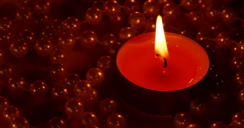 Romantic setting lit candles and pearl beads Stock Footage 142575136