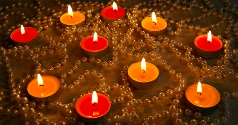 Romantic setting lit candles and pearl beads Stock Footage 142575376