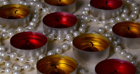 Romantic setting lit candles and pearl beads Stock Footage 142723249