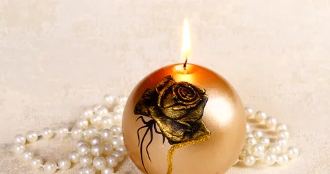 Romantic setting lit candles and pearl beads Stock Footage 142725342