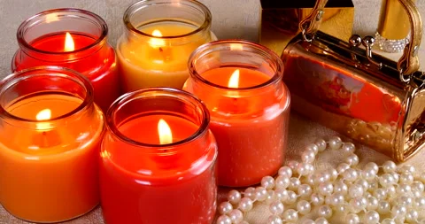 Romantic setting lit candles and pearl beads Stock Footage 142726853