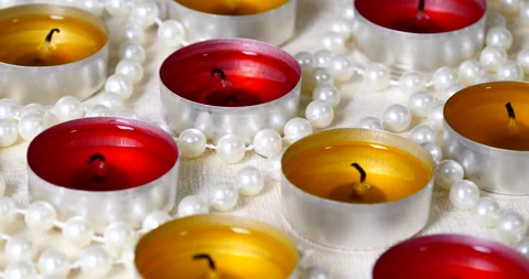 Romantic setting lit candles and pearl beads Stock Footage 142772827