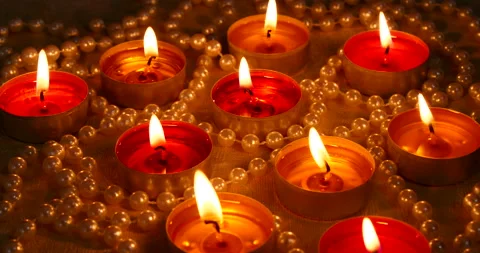 Romantic setting lit candles and pearl beads Stock Footage 142774764