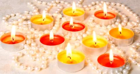 Romantic setting lit candles and pearl beads Stock Footage 142777562