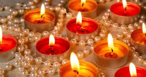 Romantic setting lit candles and pearl beads Stock Footage 142809080