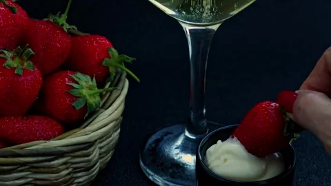 Romantic setting with strawberries and sparkling white wine, strawberries with c Stock Footage 309410061