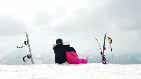 Romantic skier couple embracing time together sit on snow outdoors on vacat.. Stock Footage 342963460