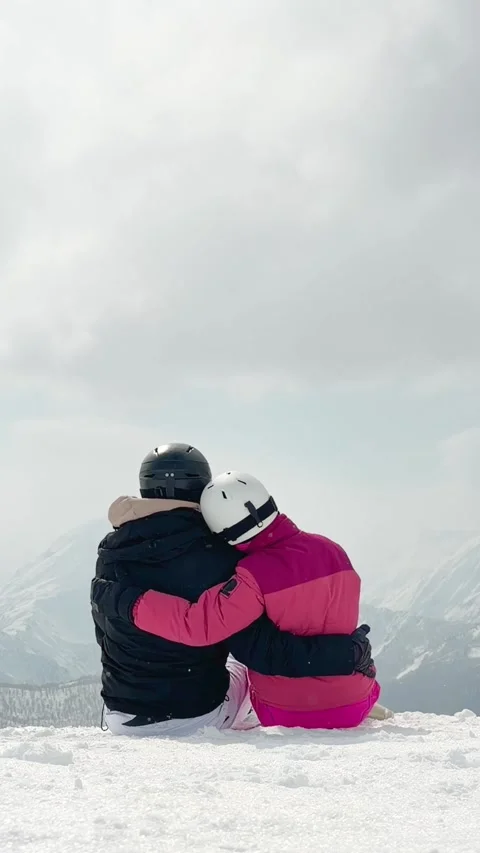 Romantic skier couple embracing time together sit on snow outdoors on vacat.. Stock Footage 342963634