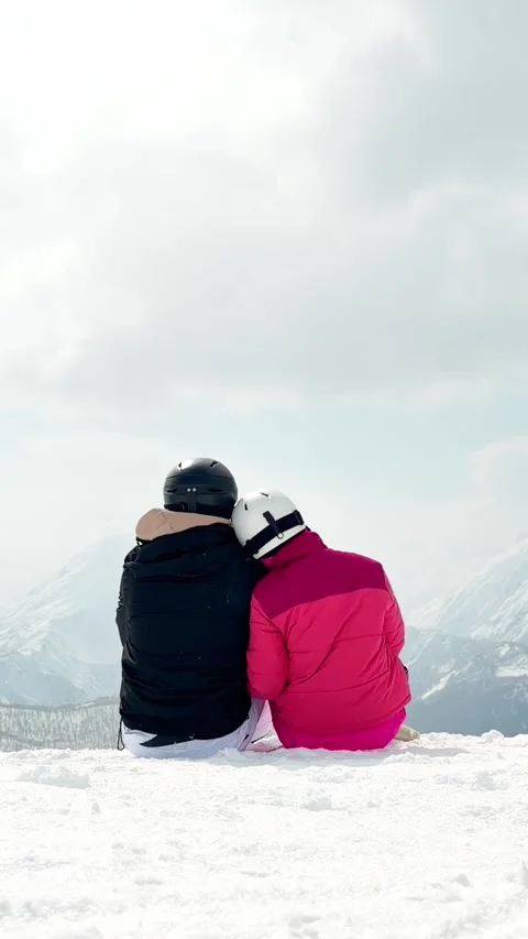 Romantic skier couple embracing time together sit on snow outdoors on vacat.. Stock Footage 343553119