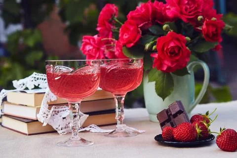 Romantic summer table settings. Couple glasses of red strawberry wine. Natural Stock Photos