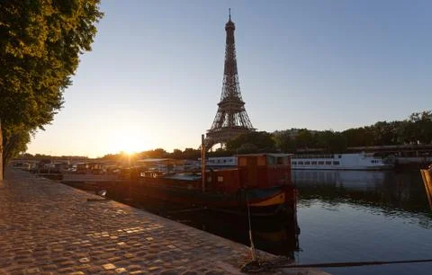Romantic sunset background. Eiffel Tower with boats on Seine river in Paris . Stock Photos