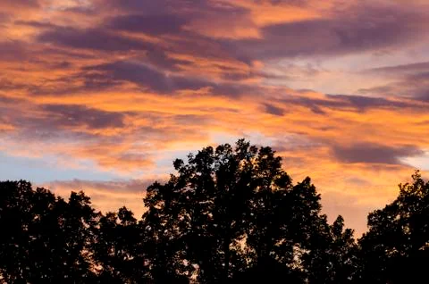 Romantic sunset with clouds and dramatic sky Stock Photos
