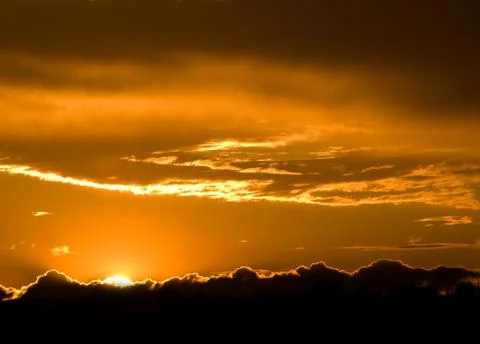 Romantic sunset with clouds and orange sky Stock Photos
