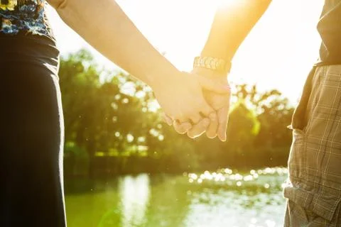 Romantic sunset with hands. Stock Photos