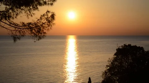 Romantic sunset at the sea. Sun going down over horizon Stock Footage 107880650