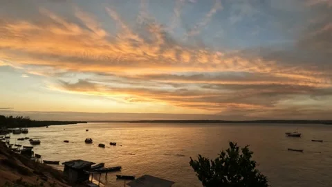 Romantic sunset in a tropical landscape. Clouds golden by the sun Stock Footage 220558811
