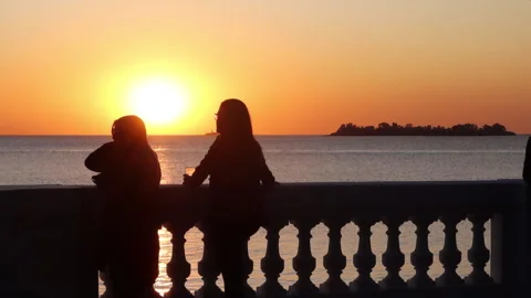 Romantic sunset view and people enjoying ocean view Stock Footage 250047009