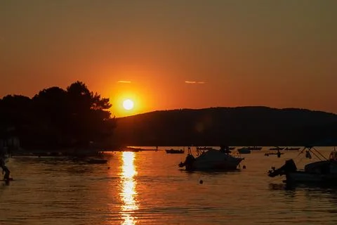 Romantic sunset view from beach in small fishermen village Vourvourou, Gree.. Stock Photos