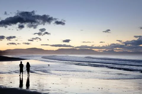 Romantic sunset walk along Byron Bay beach. Stock Photos