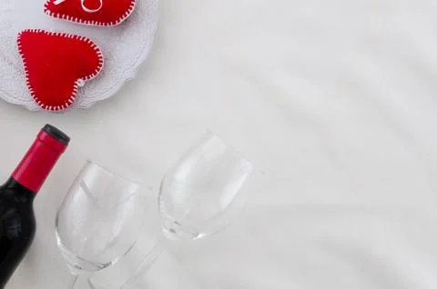 Romantic table with bottle red wine and wine glasses. Flat lay decorated with Stock Photos