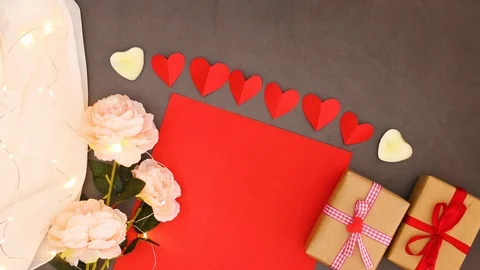 Romantic table with flowers, red paper and gifts for Valentine - Stop motion Stock Footage 123137482