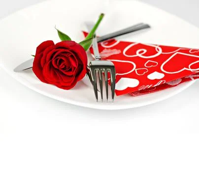 A romantic table setting with rose on a white background close up Stock Photos