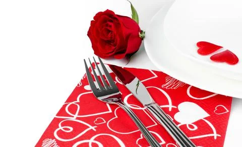 A romantic table setting with rose on a white background close up Stock Photos