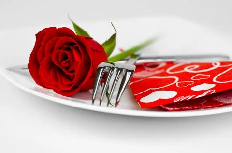 A romantic table setting with rose on a white close up Stock-Fotos