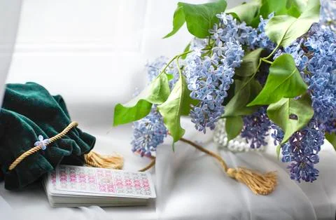 Romantic Tarot Setup Background. Tarot cards and lilac flowers. Stock Photos