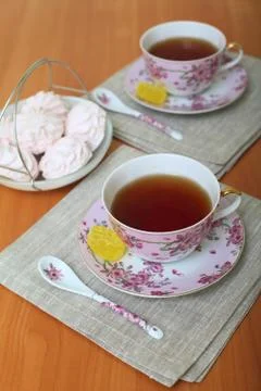 Romantic tea served in beautiful cups with marshmallow Stock Photos