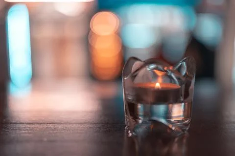 A romantic tealight in the dark on a table Stock Photos