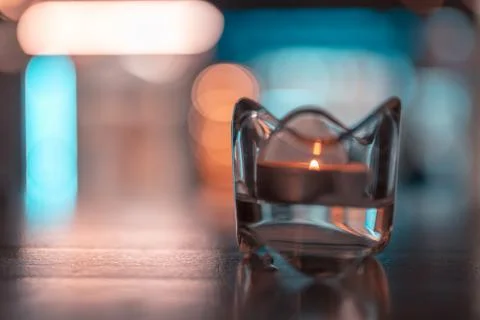 A romantic tealight in the dark on a table Stock Photos