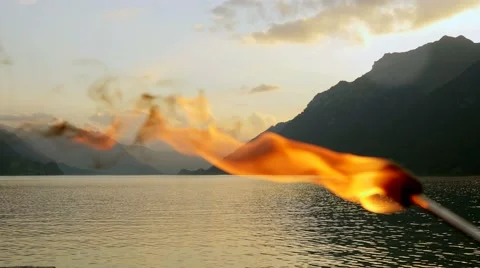 Romantic torchlight burning in front of lake panorama at twilight sky Stock Footage 42907400