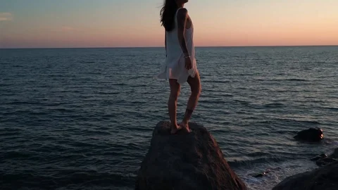 ROMANTIC VACATION ON THE SEASIDE. Young lady watch and surprised by sunset. Video stock 101747802