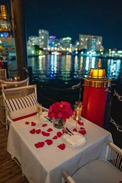 Romantic Valentine's Day table setting on water with city skyline Stock Photos