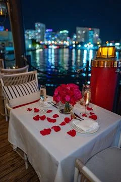 Romantic Valentine's Day table setting on water with city skyline Stock Photos