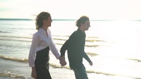 A Romantic Walk on the Beach at Sunset, filled with joy and love, creating Stock Footage 281452209