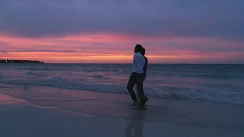 Romantic Walk Through Ocean Waves on Beach, Married Couple at Sunset Stock Footage 112481144