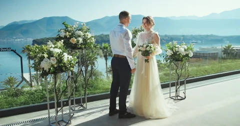 Romantic wedding couple looking to each other and smiling holding hands Stock Footage 137906603